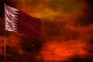 Fluttering Qatar flag mockup with blank space for your text on crimson red sky with smoke pillars background. Troubles concept.