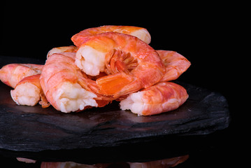 Healthy diet food: boiled wild tiger shrimps close-up on a plate on a table