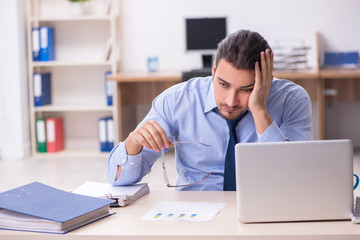 Sick male employee suffering at workplace