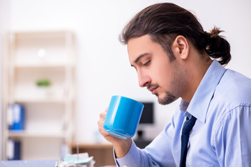 Sick male employee suffering at workplace