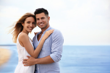 Happy couple on beach, space for text. Romantic walk