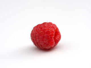big fresh juicy raspberries on a white saucer close up, macro photo, selected focus