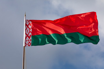 Close-up view of the national flag of the Republic of Belarus fluttering in the wind against the sky on a sunny day