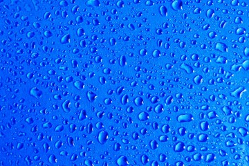 abstract image of a water droplet on a blue background. concept of water droplet structure for a postcard or banner background