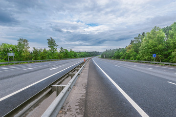 Naklejka premium View of the new highway at cloudy summer morning.