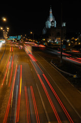 Fototapeta na wymiar Light streaks in traffic at night on Highway 94 in Minneapolis with the Basilica of Saint Mary
