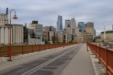 Minneapolis highrise tower skyline from the Stone Arch Bridge at sunrise