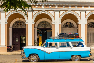 Old blue and white retro car in the center of cuban city Cienfuegos, Cuba