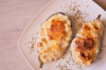 Aubergines stuffed with bacon, tuna, ham, cheese and bechamel