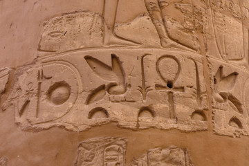 Egyptian ancient hieroglyphs on the stone wall. Closeup of the symbol of eternal life ankh