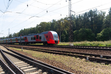 Fototapeta premium Pociąg pasażerski na szynach. Kolej żelazna.
