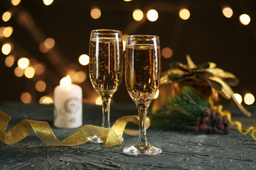 selective focus of glasses full of champagne against christmas lights