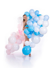 Nude girl with balloons posing on a white background.