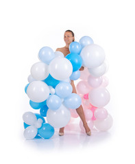 Nude girl with balloons posing on a white background.