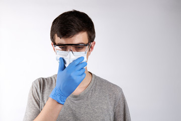 caucasian male person wearing protective glasses and face mask over white background. copy space. person coughing. illness concept