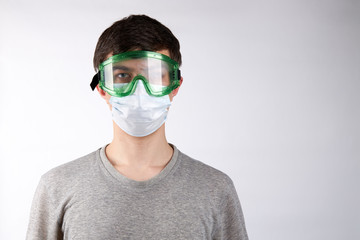 caucasian male person dressed casual clothes over white background. copy space. mid age man with blue eyes. wearing protective glasses and face mask