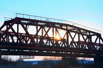 Old steel railway bridge on the river. Empty train bridge