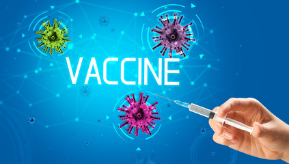 Syringe, medical injection in hand with VACCINE inscription, coronavirus vaccine concept