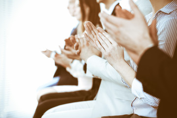 Business people clapping and applause at meeting or conference, close-up of hands. Group of unknown...