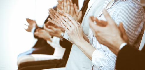 Business people clapping and applause at meeting or conference, close-up of hands. Group of unknown...