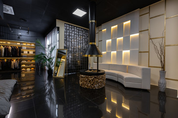 dark modern stylish male apartment interior with lighting, decorative walls, fireplace, dressing...