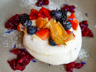 Pavlova cake with cream and fresh summer berries