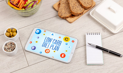 Healthy Tablet Pc compostion with LOW CARB DIET PLAN inscription, weight loss concept
