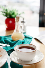 Obraz na płótnie Canvas photos of dishes of tea in the café a bright Sunny natural light