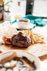 photos of dishes grilled meat French fries in cafes bright Sunny natural light