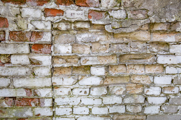 Embossed textured surface of an old wall made of facade bricks and cement