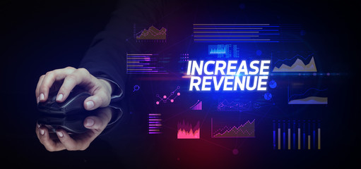 hand holding wireless peripheral with INCREASE REVENUE inscription, cyber business concept
