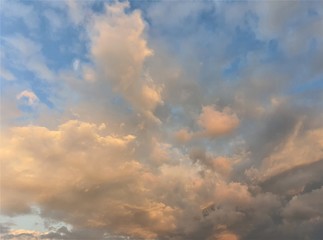 Naklejka na ściany i meble orange-gray clouds on blue sky during sunset, summer sunset