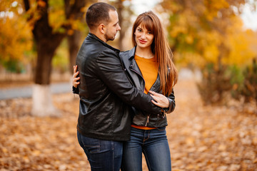 Fototapeta premium couple hug in autumn park near river.