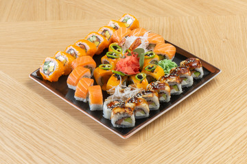 Sushi set of different rolls with eel, tuna, salmon, shrimp, ginger, daikon radish, and wasabi. Asian traditional food.
