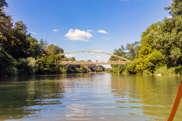 Fototapeta premium The river flows through the resort town of Goryachy Klyuch. Bridge over a mountain river.