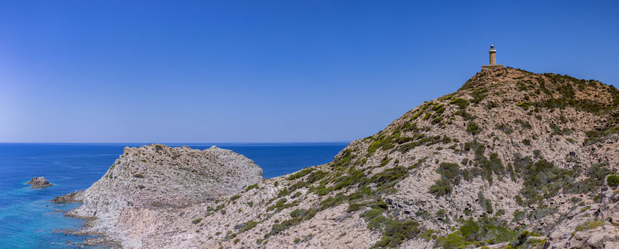 Panoramic view of Mediterranean Sea with lighthouse from Belvedere di Capo Sandalo, Carloforte, Sardinia, Italy
