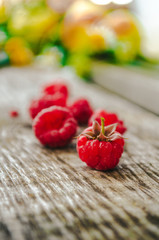 Raspberries on a wooden bench in the village
