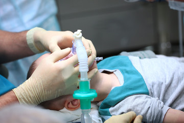 Introduction of the child into General anesthesia before surgery. The device of artificial ventilation of lungs.Copy of the space. Unrecognizable photo.