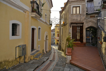 A narrow street between the old houses of San Nicola Arcella, a village in the region of Calabria, Italy.