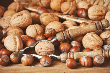 Different nuts and nutcracker  on wooden table