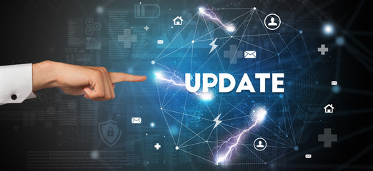 Hand pointing at UPDATE inscription, modern technology concept