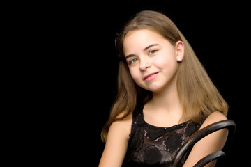 Fototapeta premium Close-up.Portrait of a cute little girl on a black background.