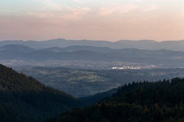 Naklejka premium Panorama at sunset from the mountains of the Black Forest near Gersbach over the Wehratal and the city of Wehr towards the Swiss Alps