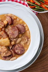 .Puchero. Dish made with white beans, chickpeas, sausage, bacon and vegetables. Dish of Spanish origin very common in Brazil and South America. Top view.
