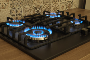 Natural gas burning by blue flames in kitchen stove. Food cooking concept.