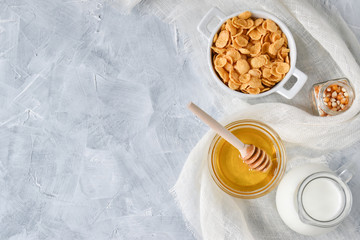 Oatmeal with honey and milk, from the left there is a place for the text. Healthy diet. Flat lay.