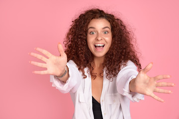 Come to me, let me hug you. Studio shot of thrilled overwhelmed redhead female pulling hands towards camera with affection in eyes, feeling desire to cuddle and express passionate emotions