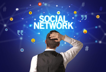 Rear view of a businessman with SOCIAL NETWORK inscription, social networking concept