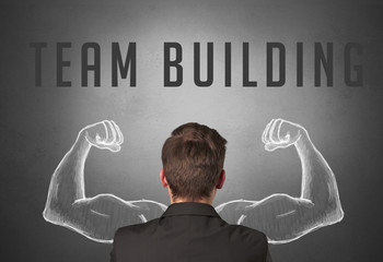 Rear view of a businessman with TEAM BUILDING inscription, powerfull business concept
