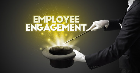 Illusionist is showing magic trick with EMPLOYEE ENGAGEMENT inscription, new business model concept